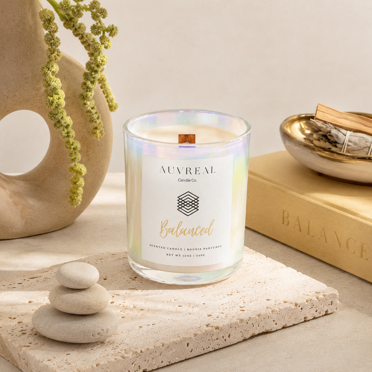 Auvreal candle with 'Balanced' text on a neutral background with decorative elements.